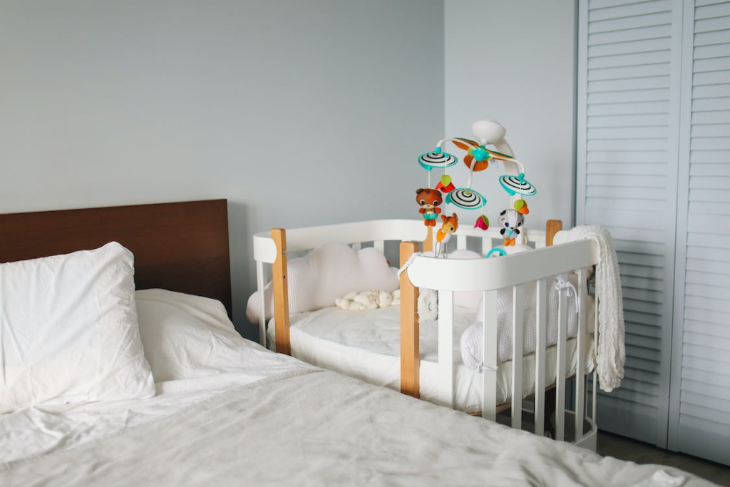 a portable crib in the parent’s bedroom